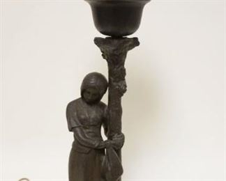 1141	TABLE LAMP CAST METAL IMAGE OF WOMAN W/HER ARMS WRAPPED AROUND A TREE TRUCK CLUTCHING A BAG W/AMBER MUSHROOM SHADE AT TOP, APPROXIMATELY 18 1/4 IN
