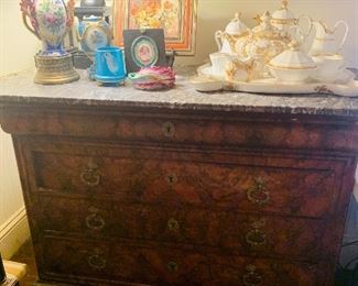 French cabinet  number 1 of the matching  French cabinets complete with all original hardware   and marble tops.  Also can you see the Old Paris coffee and tea service, the blue Opaline, the painted porcelain lamp and the two paintings by noted Louisiana artist Nolan Braud?