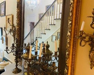 beautiful rococo style gilded mirror and notice the wall sconces and  garniture  of a French mantle  clock and matching  pair  of  candleabras