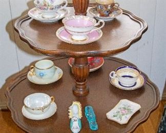 Antique threetiered mahogany dumbwaiter display butler table with serpentine legs (shown with antique tea cup sets sold separately.