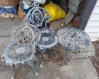 Cast aluminum outdoor table and chairs - 1 chair needs repair