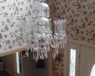 Lovely crystal chandelier. Need tall ladder to get down.