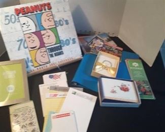 Miscellaneous office items. Pads of paper, post cards, thank you cards, and a Peanuts calendar and more