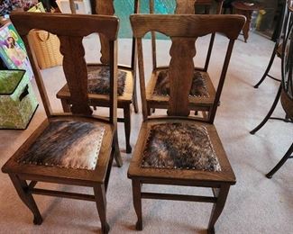 (4) Vintage chairs. All have been reupholstered with Buffalo hide. Very nice