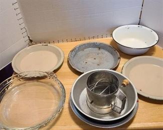 Enamelware, glass, aluminum pie pans and a sifter