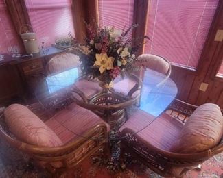 Sunroom glass top dinette with 4 rolling chairs