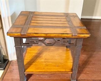 Wood and metal end table with inlaid leather.
