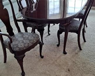 Ethan Allen cherry dining table 65x44, with 4 side chairs and 1 armed chair and 2 19inch leaves