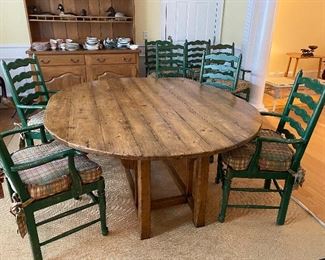 (F15) Antique Drop Leaf Table (similar to a harvest table size) Measures 6' x 5' wide with leaves up and 8 coordinating chairs with cushions. Rush seats are all in excellent condition. Chairs are sturdy but some do need some glue on the arms where it meets the chair back - nothing broken just noted.  Table surface does have some scratches in the finish but overall very good condition for it's age. Hardware has been replaced on the underside of the table at some point.  GORGEOUS set. Asking $1750. 
