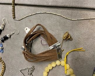 Rawhide bracelet, tie tac, & goldtone necklace. 