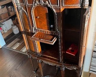 Antique liquor cabinet. All drawers open in different directions 