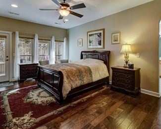 Sleigh bed, two matching nightstands and rug.
