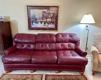 Top grain tufted leather sofa. Nail head trim, bun feet, an easy fit into any decor