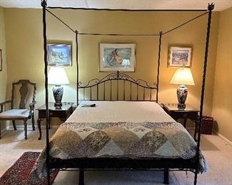 High top square canopy four post wrought iron bed with scrolled top finials.