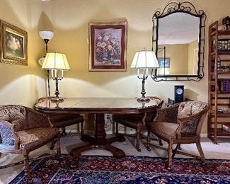 Drexel Heritage Grand Villa dining table, with additional leaf, and four barrel and caned back chairs on brass casters.