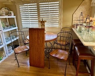 Oak and wrought iron dining table and four chairs,one additional leaf with protective cover