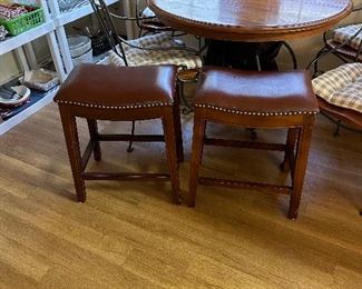 Two faux leather, nail-head trimmed bar stools
