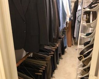 Lots of mens suit, shirts, ties, leather belts and pants,