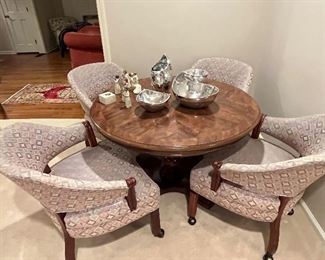 Round card table, one leaf, and 4 club chairs in casters