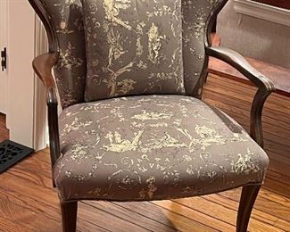 Brown and cream upholstered arm chair with matching pillow