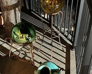 Yard globes on stands, gold and green, and turquoise pot lying in stand