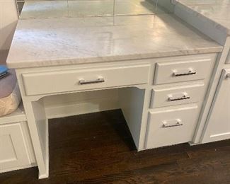 Marble top desk area with cabinets