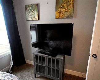 grey cabinet and TV