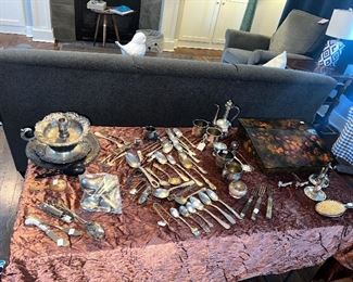 lots of vintage and antique silver and advertising utensils