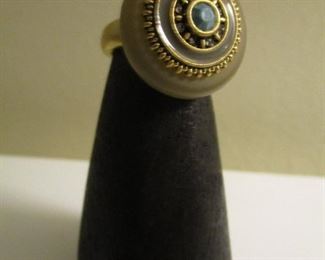 COSTUME GOLD TONE RING WITH A BLUISH STONE.   
 SIZE 6 3/4      $20