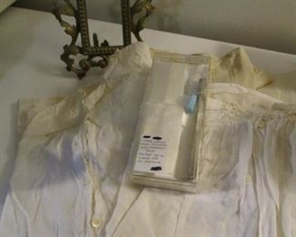 LOT OF VINTAGE BABY GOWNS, A SMALL BRASS FRAME AND A STERLING HANDLED  BABY'S TOOTHBRUSH.    $20