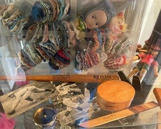 vintage items: quilt fabric yoyo dolls, wooden Pinocchio, wood box, wood knife, collectible postcards, compass, Six Flags mini bat,