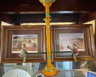 pair of small framed Jack Deloneys, metal teeter totter bank