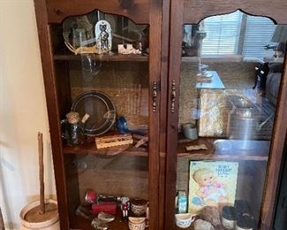 small display cabinet with collectibles, another churn