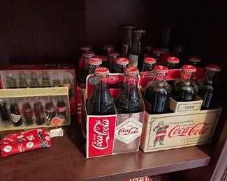 all kinds of Coca Cola collector bottles