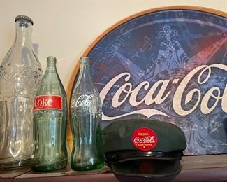 glass bottles, delivery man hat, cardboard sign