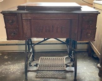 White Sewing Machine in advertising cabinet