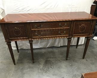 LOT 3 Mahogany Sheraton Style Sideboard
measures 65" x20" x38" tall Councill sideboard 2 door storage areas 2 drawers one is lined and designed for silver, ornate carved bouquet wood onlay, banded top.