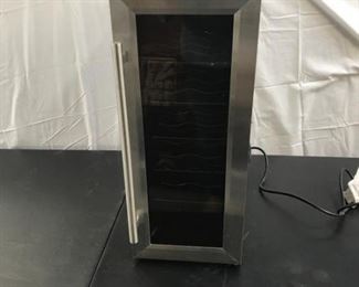 Lot 143 Thermo- Electric Wine Cooler
holds 10 bottles, has temperature control knob and light Measures: 10 1/4" x 19 1/2" x 29".