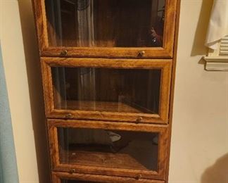 Four shelf glass front bookcase