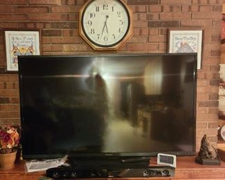 Large flat screen TV with soundbar