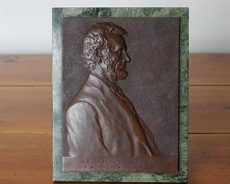 V. D. Brenner's classic Abraham Lincoln Bronze plaque on green marble.  Lower right has "Copyright 1907 by V. D. Brenner". To the left of that is the arrow/oval logo with 1907, The bottom of the plaque reads ABRAHAM LINCOLN **1809 * 1865 **.  Affixed to green marble with a bronze fully functioning easel marked S. KLABER & CO. / FOUNDERS N. Y.  One of the most familiar pieces of art in U.S history with billions circulating every day in the form of the Lincoln Cent.  This is probably from the first set of castings, being marked on the reverse with the Foundry name.