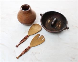 Group of wooden items, African bowl with carved animal on the interior, 9 1/2” across and 23/4” tall; African giraffe handled salad servers, 11” long; turned wood vase with glass insert, wood cracked on side, 7” tall.