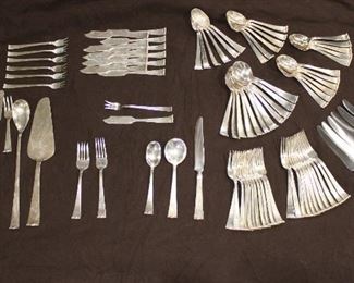 Alan Adler Sterling Silver Flatware, 94 pieces, plus one sugar spoon and plus one damaged teaspoon. 12 Each dinner knives, soup spoons, dinner forks, salad forks, butter knives, 23 teaspoons, 7 seafood forks, master butter knife, small fork, pastry/cake server, and long spoon.