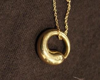 Elsa Peretti 18K Yellow Gold Eternal Circle Pendant on a Tiffany & Co. 28" gold chain.