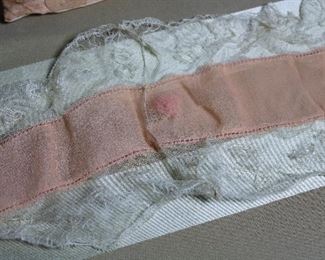 Antique boudoir cap, two crochet lace sachets, and lace and silk belt with ribbon roses