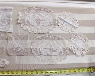 A group lot of antique lace trim and medallions,  Many medallions are figural with dogs, cherubs, etc.