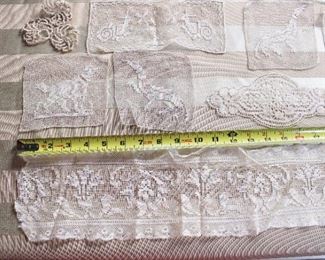 A group lot of antique lace trim and medallions,  Many medallions are figural with dogs, cherubs, etc.