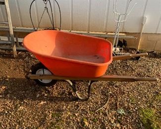 #216	outside	orange wheelbarrow with wood handles	 $30.00 			
