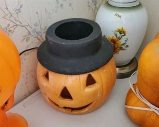 There are 4 or 5 ceramic or cement? heavy pumpkins