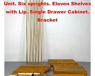 Lot 464 Oak Modernist Wall Shelf Unit. Six uprights. Eleven Shelves with Lip. Single Drawer Cabinet. Bracket